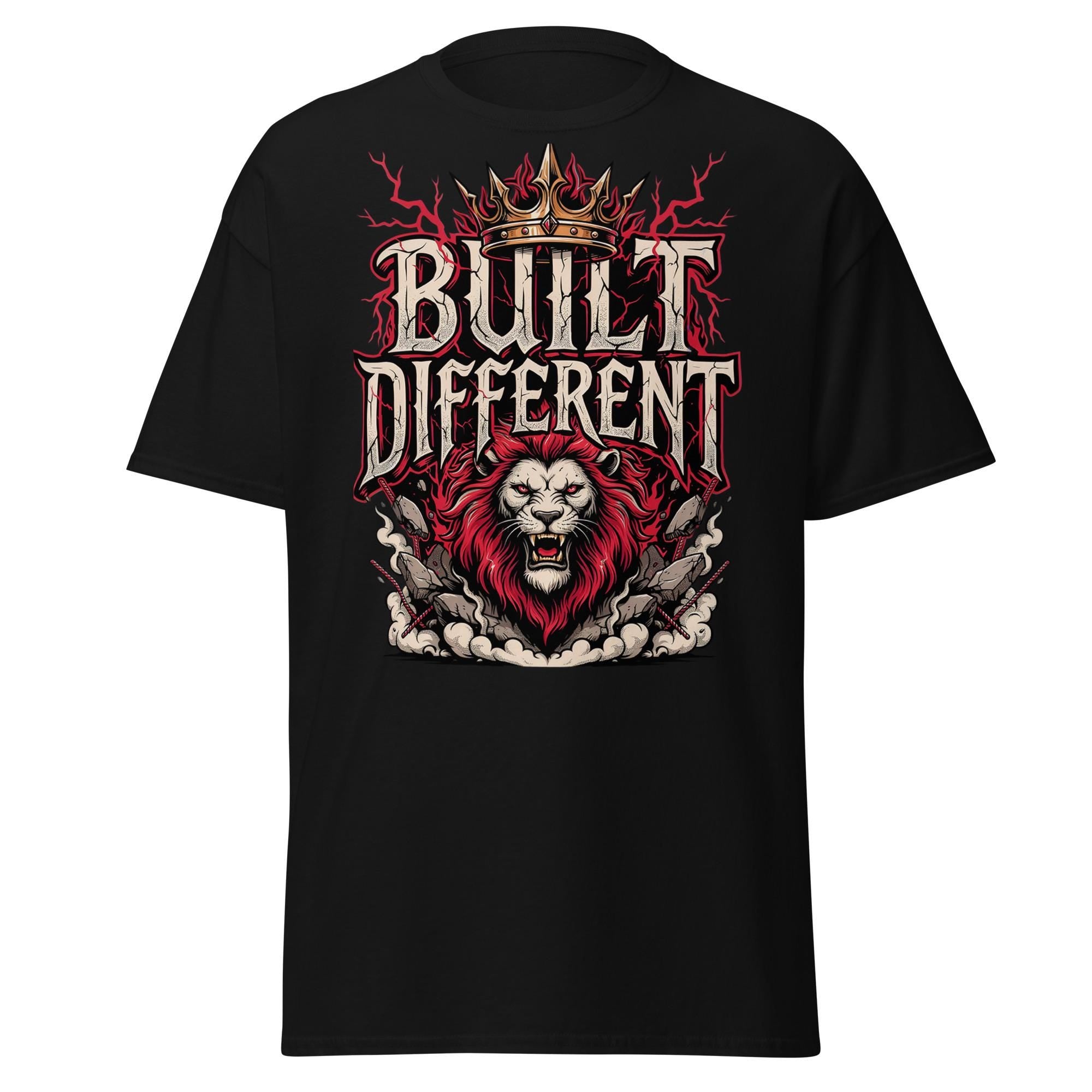 A black short-sleeve crewneck t-shirt featuring a large graphic print on the front. The graphic displays a roaring lion with a red mane beneath the words 'BUILT DIFFERENT' in a stylized white and red font, topped with a gold crown and red lightning bolts.