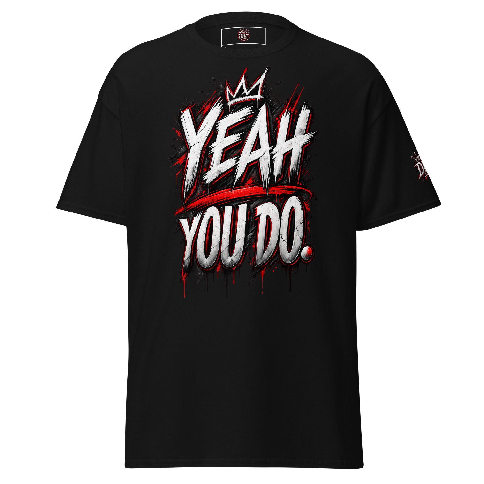 A black short-sleeve t-shirt with a bold graphic on the front reading 'YEAH YOU DO.' in white and red graffiti-style lettering, with a small crown graphic above the text.