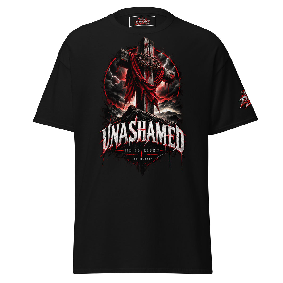 A black short-sleeve graphic t-shirt featuring a large gothic-style print on the front of a cross draped in red cloth, surrounded by storm clouds and lightning, with the text 'UNASHAMED' and 'HE IS RISEN' below. A smaller matching graphic is visible on the right sleeve.