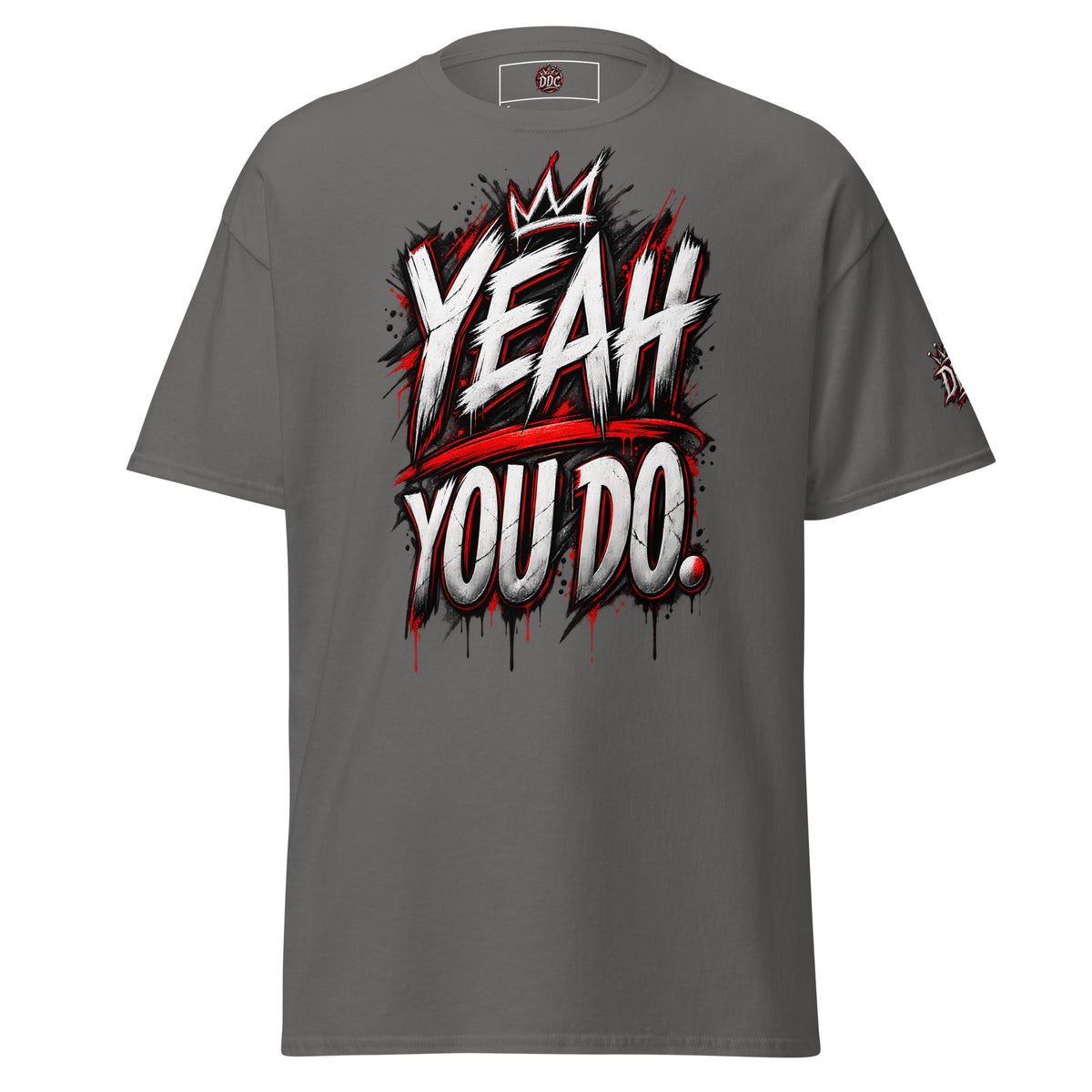 A dark gray short-sleeve t-shirt with a bold graphic on the chest reading 'YEAH YOU DO.' in white and red graffiti-style lettering with a crown above, shown on a plain white background.