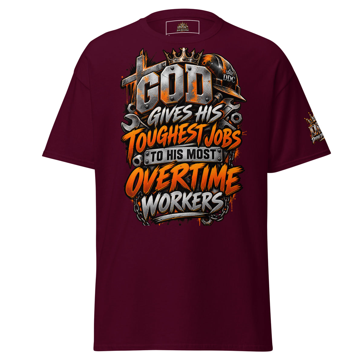 A maroon short-sleeve t-shirt with a large graphic on the front that reads 'GOD GIVES HIS TOUGHEST JOBS TO HIS MOST OVERTIME WORKERS' in orange, white, and metallic gray lettering, with a construction helmet and wrenches as part of the design. A smaller matching graphic is visible on the left sleeve.