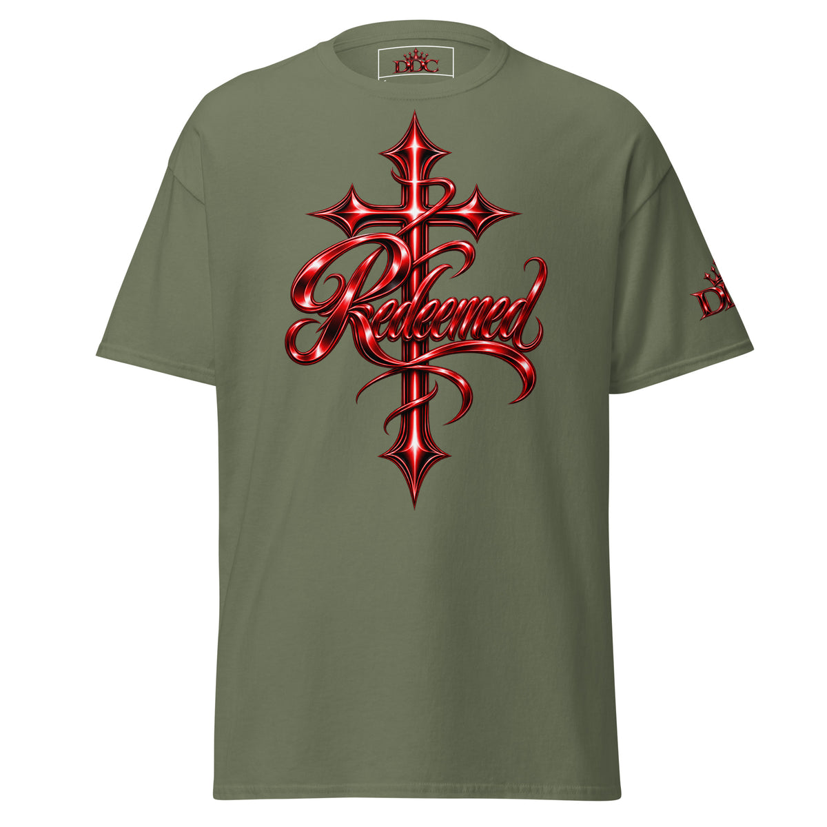 An olive green short-sleeve t-shirt featuring a large red and black metallic gothic cross graphic on the chest with the word 'Redeemed' in stylized script, shown against a plain white background.