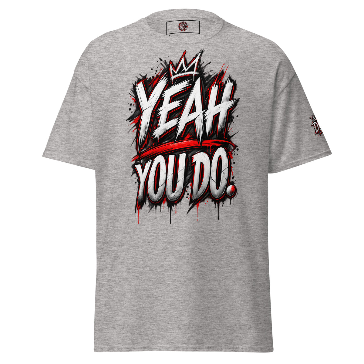 A heather gray short-sleeve t-shirt with a bold graphic on the chest reading 'YEAH YOU DO.' in white, black, and red graffiti-style lettering, with a small red circular logo printed inside the collar.