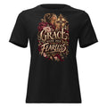 A black short-sleeve crewneck t-shirt featuring a large graphic print on the front. The graphic displays a woman in profile looking up towards a golden cross, surrounded by red and pink roses, with the words 'GRACE MADE HER FEARLESS' in a stylized gold and beige font.