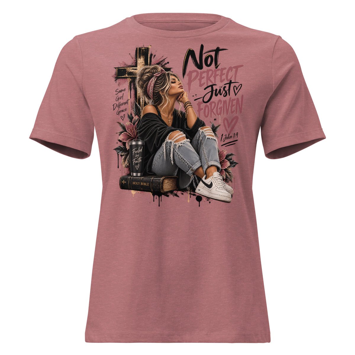 A heathered dusty rose short-sleeve t-shirt with a large graphic print on the front. The graphic features a woman sitting on a Bible next to a cross, with the text 'Not PERFECT - Just FORGIVEN' and 'Ephesians 4:22' in black and pink lettering.