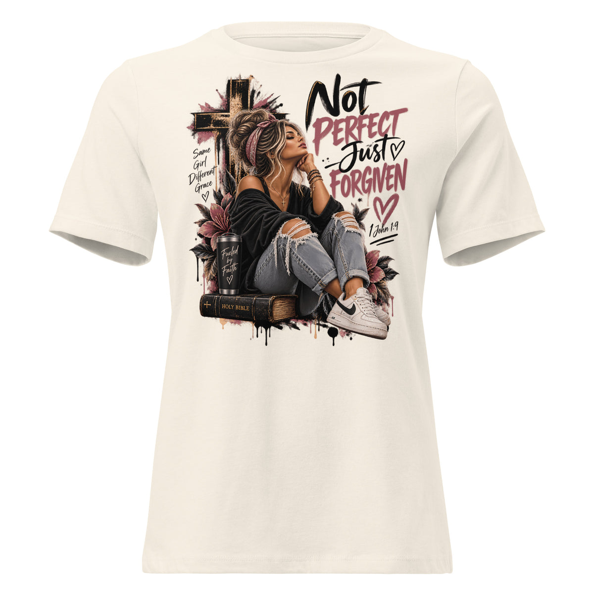 An off-white short-sleeve t-shirt with a large graphic print on the front. The graphic features a woman sitting on a Bible next to a cross, with the text 'Not PERFECT Just FORGIVEN' and 'Romans 8:14' in black and pink lettering.
