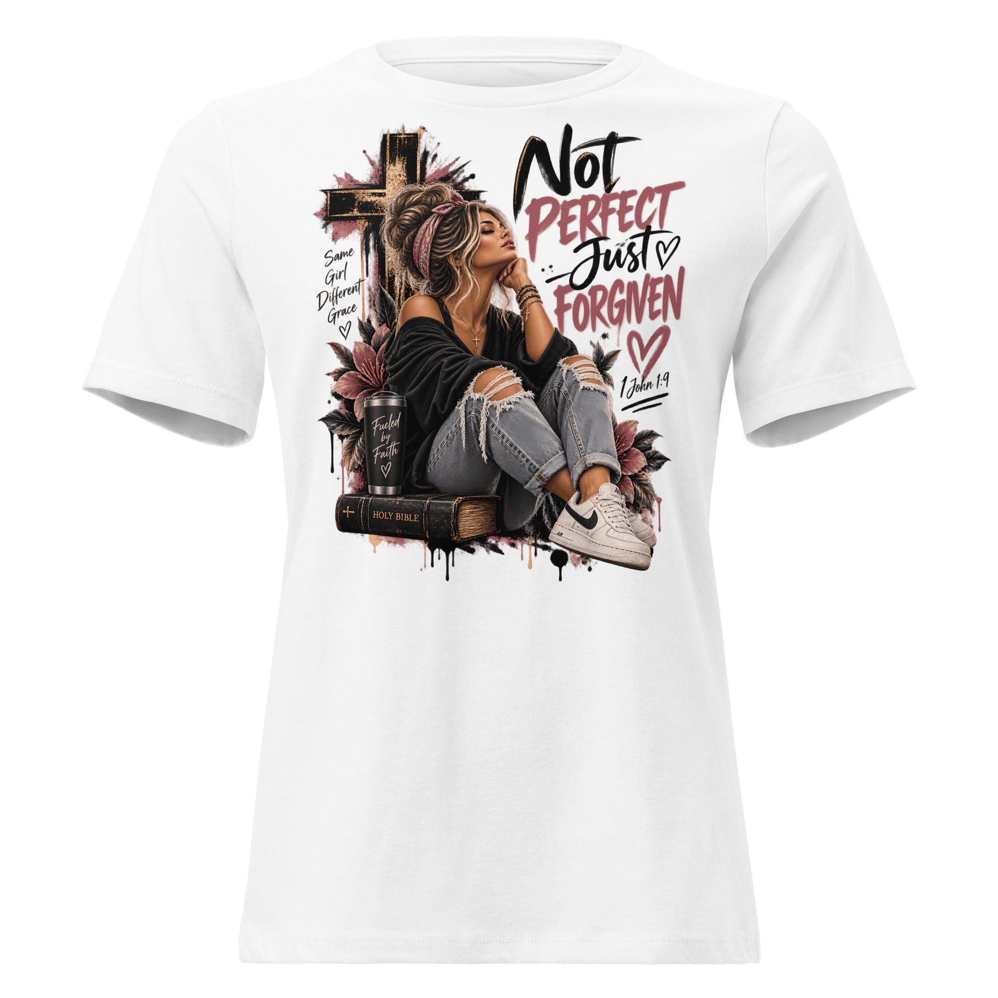 A white short-sleeve crewneck t-shirt featuring a large graphic print on the front. The graphic depicts a woman in a black top and ripped jeans sitting on a book next to a cross, with the text 'Not PERFECT Just FORGIVEN' and 'Romans 5:8' in black and pink lettering.
