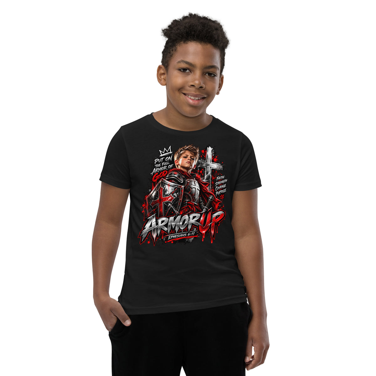 A young boy wearing a black graphic t-shirt with a red and white 'Armor Up' design, photographed against a solid white background.